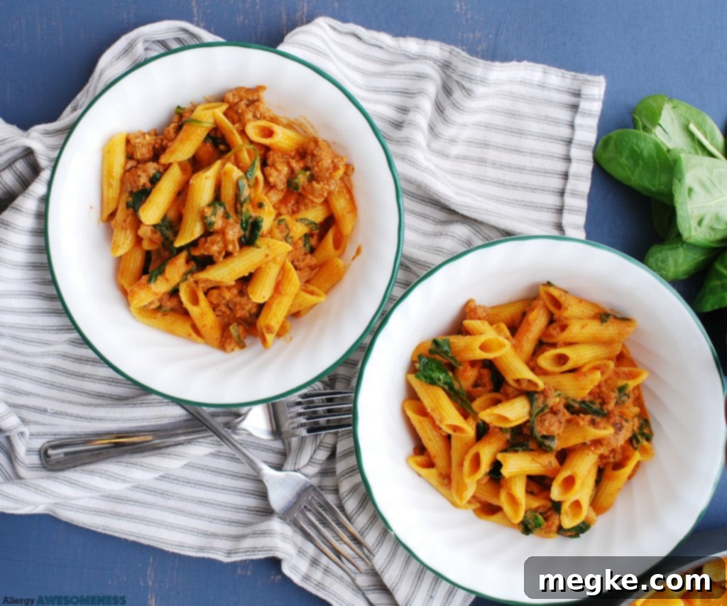 Gluten And Dairy Free Sausage And Spinach Pasta 5 allergy-friendly spinach and sausage pasta recipe being served
