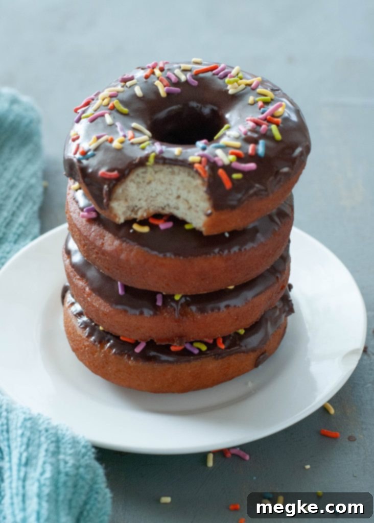 Gluten-Free Doughnuts Recipe with Video 2 Freshly fried golden gluten-free donuts stacked on a white plate