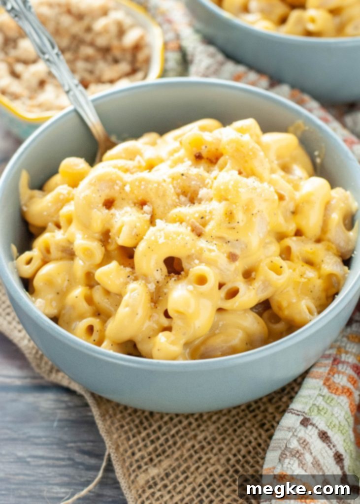 Up-close shot of creamy, thick, and gooey gluten-free mac and cheese in a blue bowl.